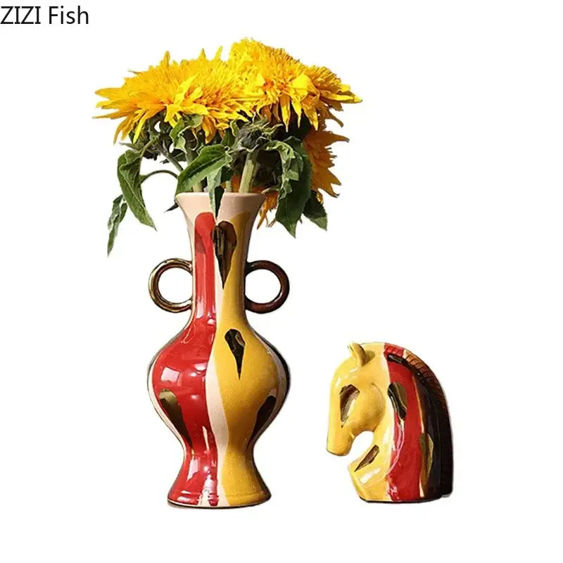 A vibrant red and yellow ceramic vase plant with dual handles and a matching horse head sculpture for living room decor