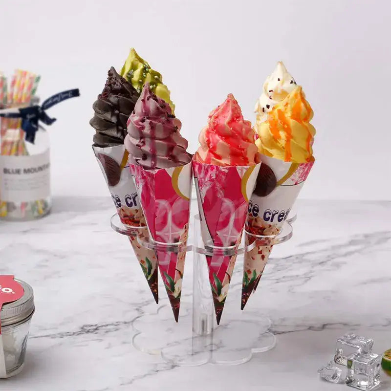 Clear acrylic ice cream cone holder display rack showing five colorful soft-serve ice cream cones with toppings