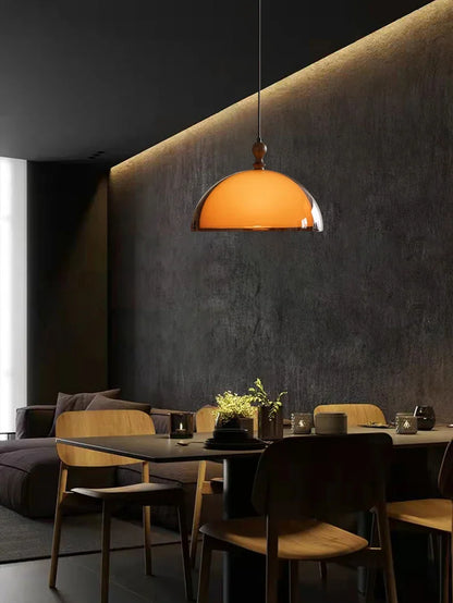 Warm amber glass acrylic pendant light with polished chrome rim and dark wood lampshade finial