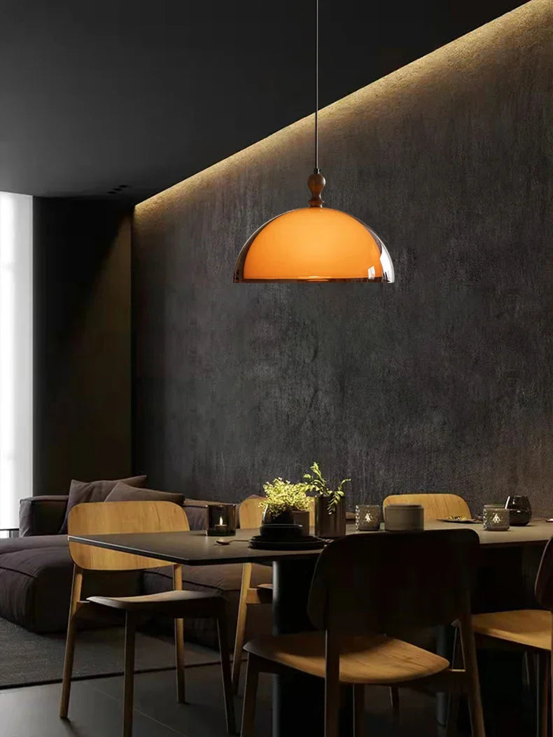 Warm amber glass acrylic pendant light with polished chrome rim and dark wood lampshade finial