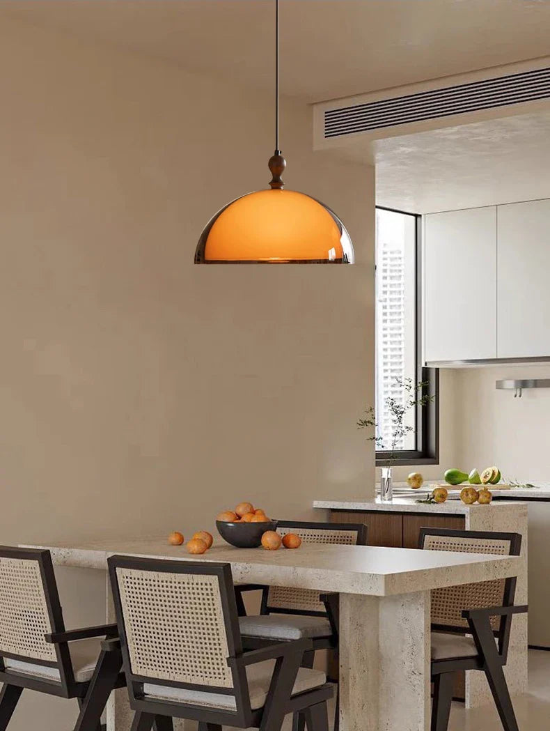 Warm amber glass pendant light with polished brass finish paired with acrylic pendant light dark wood lampshade