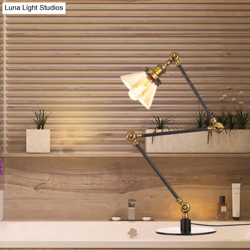 Lámpara de mesa industrial con brazo ajustable y pantalla de cristal transparente - Acabado negro/latón