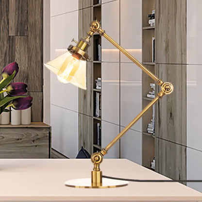 Lámpara de mesa industrial con brazo ajustable y pantalla de cristal transparente - Acabado negro/latón