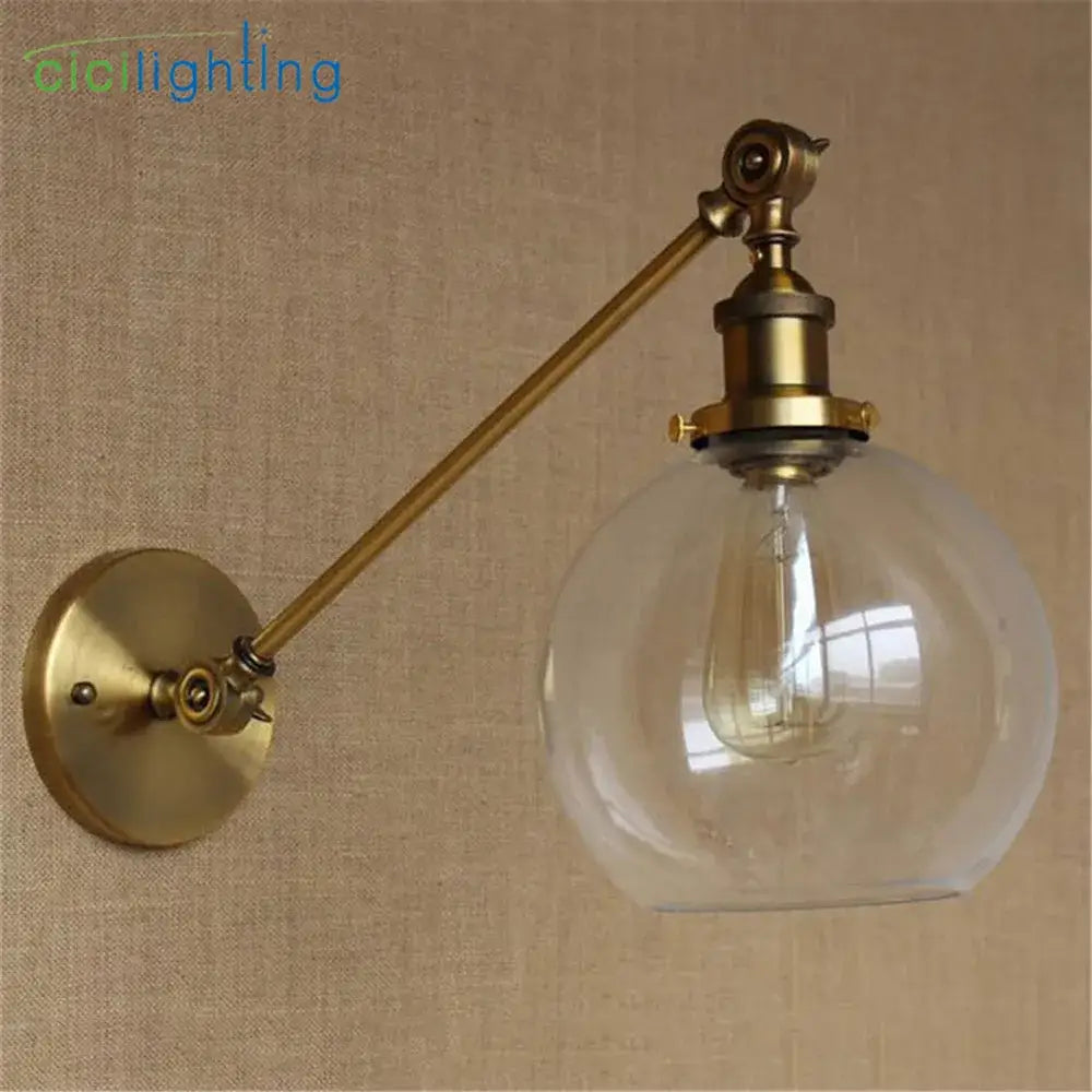 Adjustable brass wall sconce with clear glass dome and exposed filament bulb for bedroom wall lamp decorbites brass copper