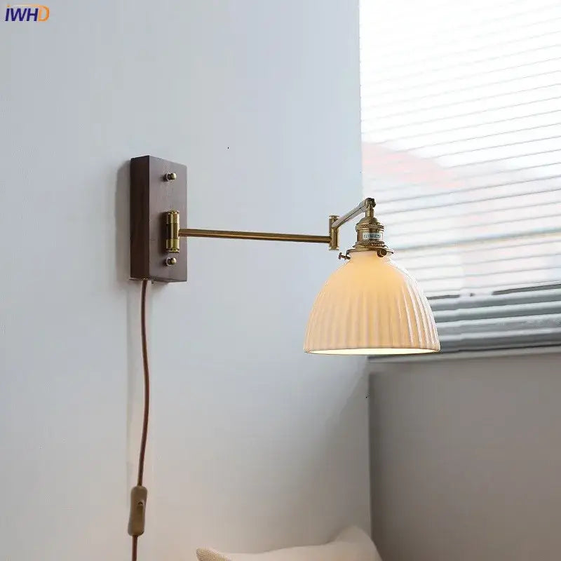 Adjustable brass wall sconce with copper arm and ribbed off-white glass shade for bedroom lighting decorbites copper arm