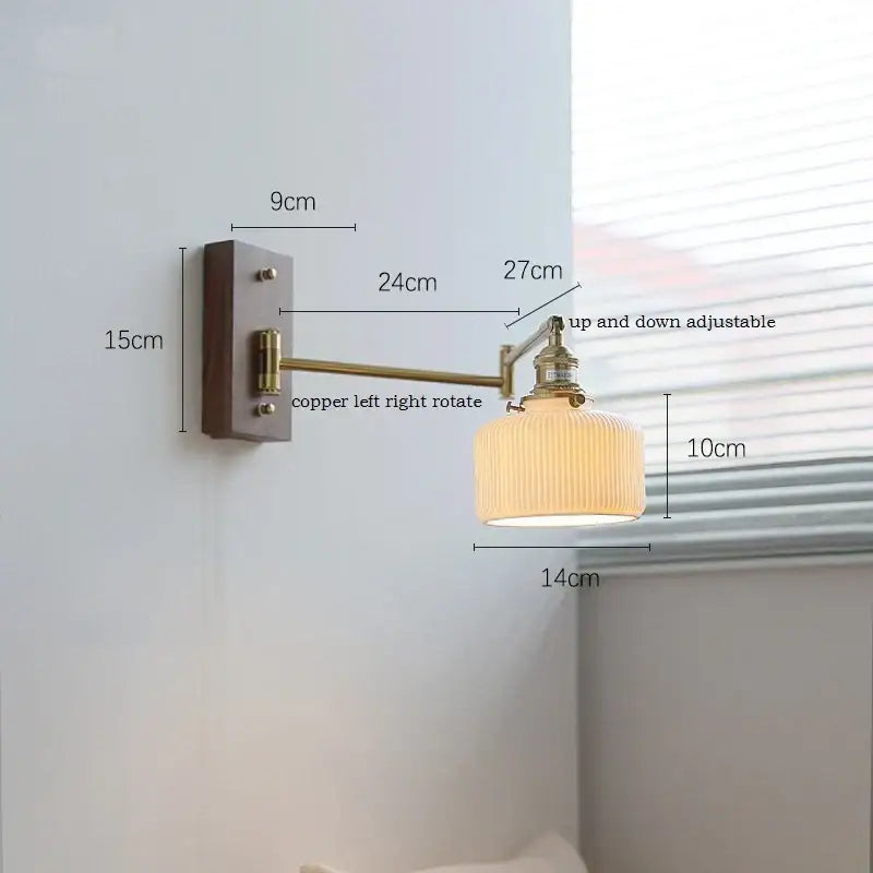 Adjustable brass wall sconce with copper arm and ribbed cream glass shade on dark wood backplate for bedroom decorbites copper arm