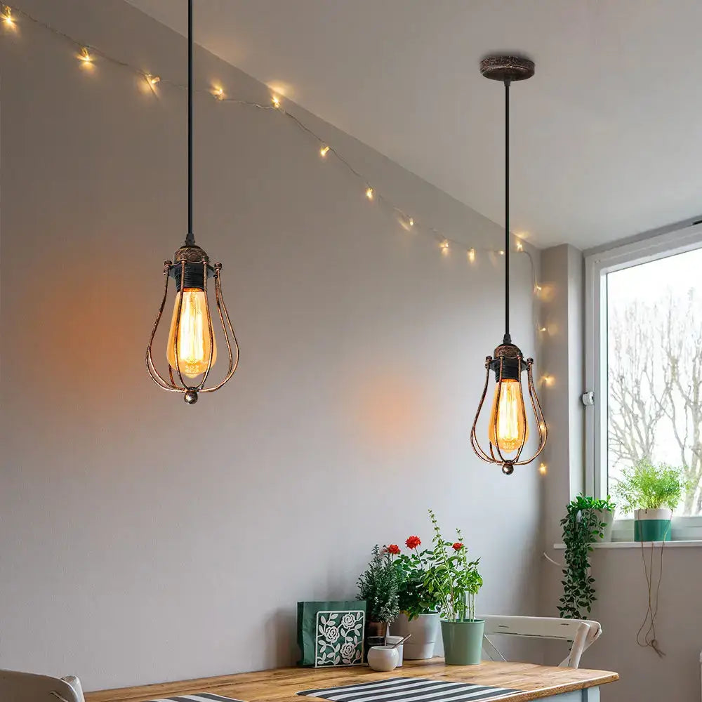 Two bronze decorbites adjustable industrial wall lights with exposed edison bulbs hang in wrought iron cages for bedroom and hallway
