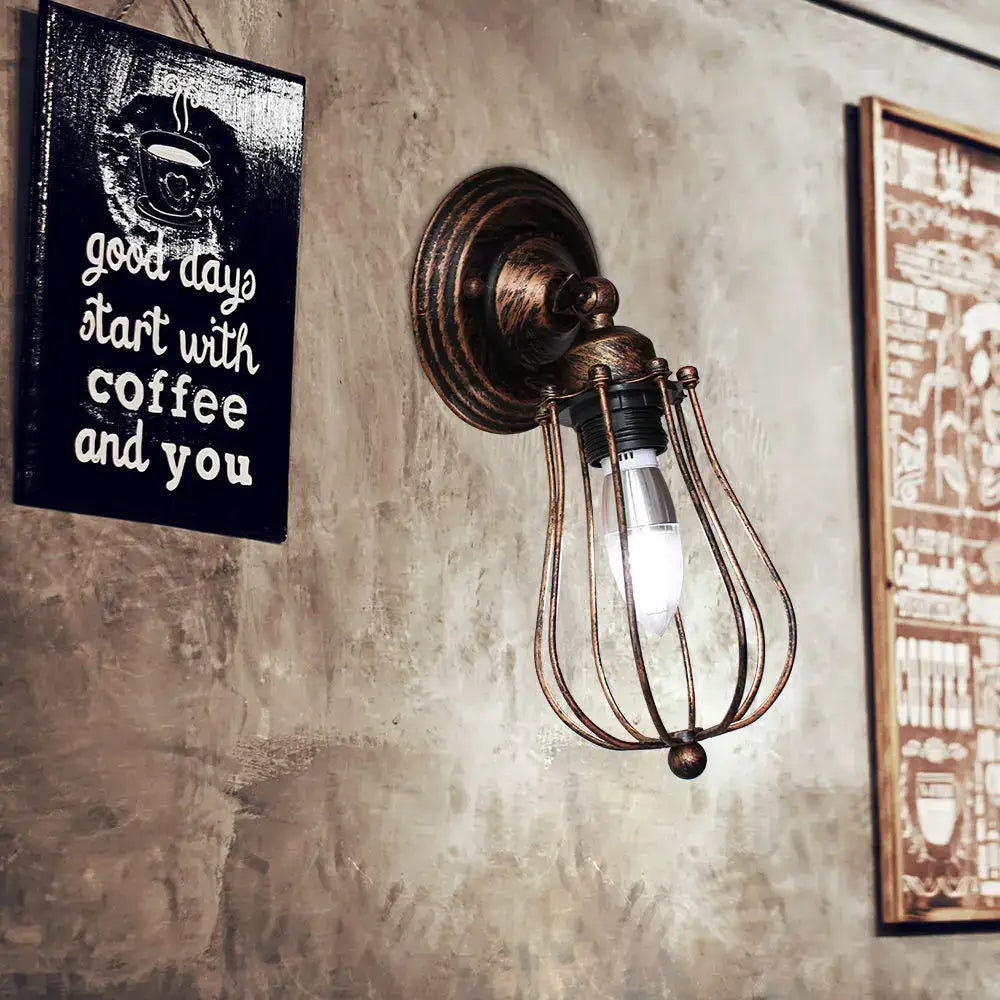 Antique brass adjustable industrial wall light with wire cage encasing exposed bulb for bedroom and hallway decorbites industrial wall light