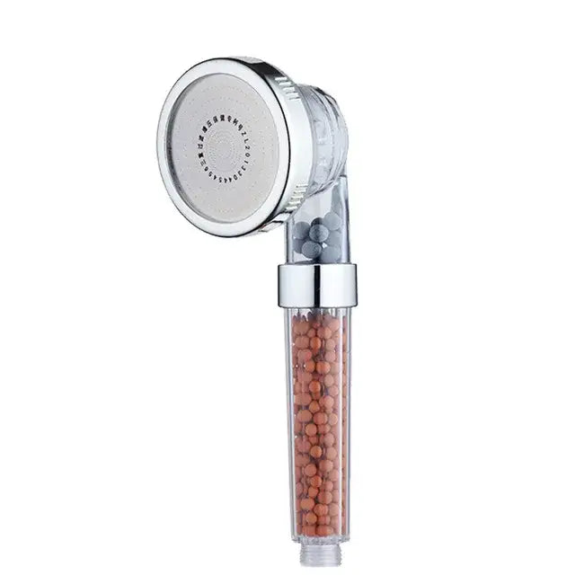Chrome finished decorbites adjustable jetting shower head with transparent body containing orange and gray filtration beads