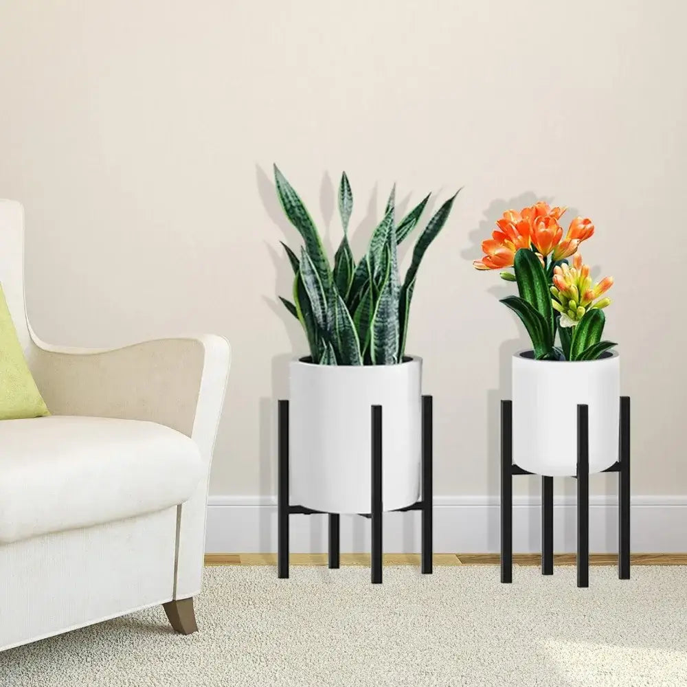 DecorBites adjustable metal plant stand in black holding white cylindrical pots with greenery and orange flowers for pots ranging 12-16 inch