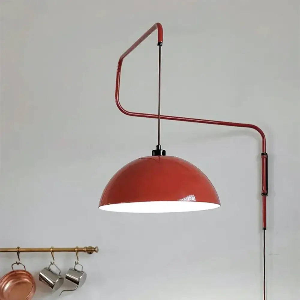 A sleek red metal adjustable nordic pendant wall lamp with a glossy terracotta dome perfect for kitchen islands