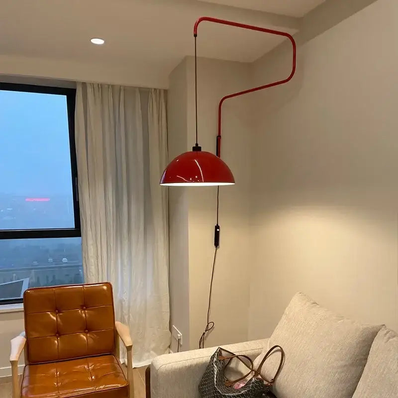 Adjustable nordic pendant wall lamp in red with a curved metal arm and glossy finish for kitchen island lighting