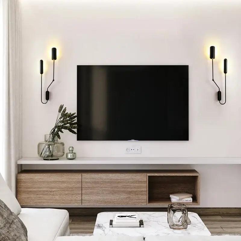 Black flat-screen television mounted on white wall showcasing decorbites adjustable retro wall lamp for bedroom reading