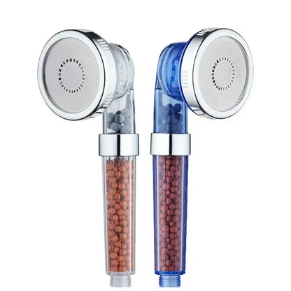 Adjustable shower head with chrome accents featuring two transparent filters with orange and reddish-brown beads