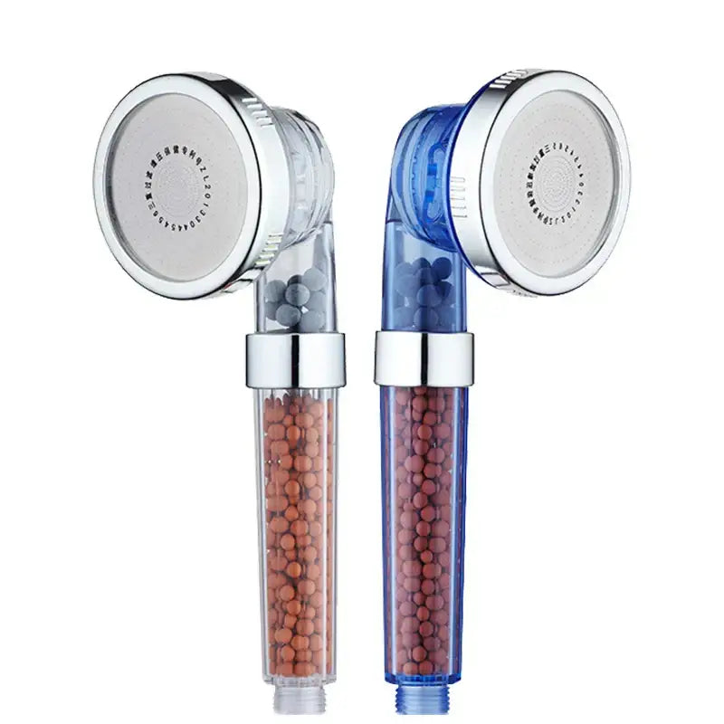Adjustable shower head with chrome accents featuring two transparent filters with orange and reddish-brown beads