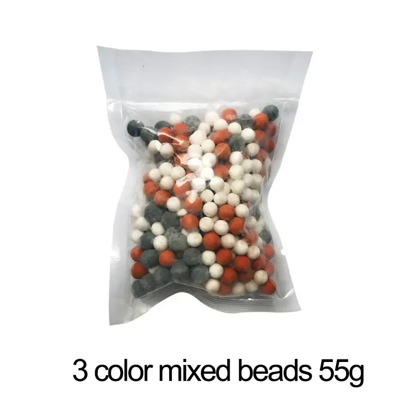 A clear plastic bag containing 55g of mixed orange white and gray filter beads for an adjustable shower head with chrome accents