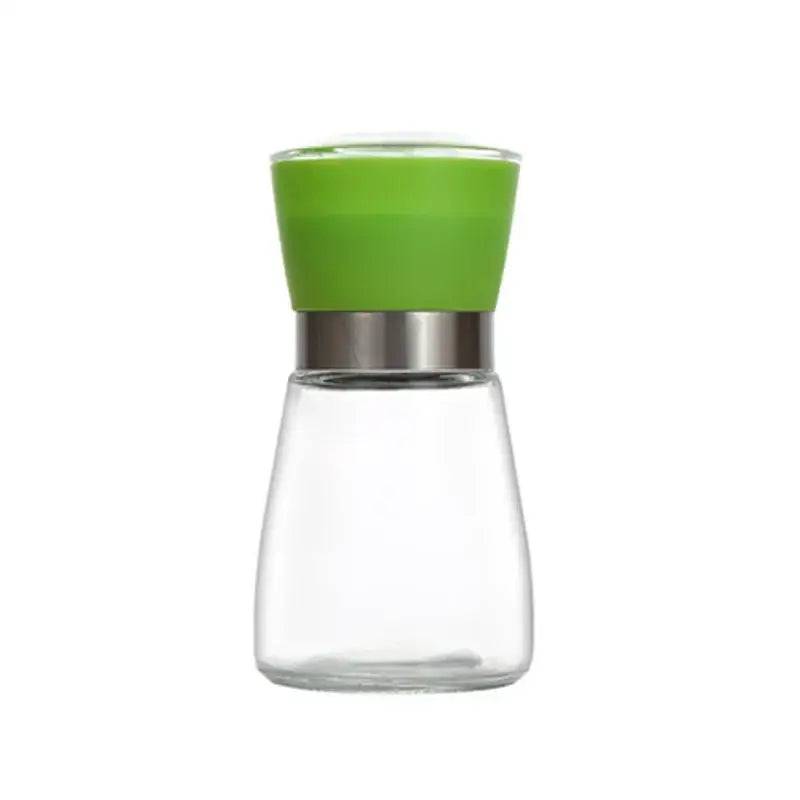 Clear glass adjustable spice grinder with vibrant green silicone top and stainless steel band for kitchen use