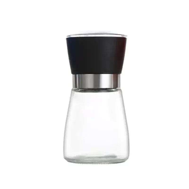 Clear glass adjustable spice grinder with black textured top and silver band from adjustable spice grinder set