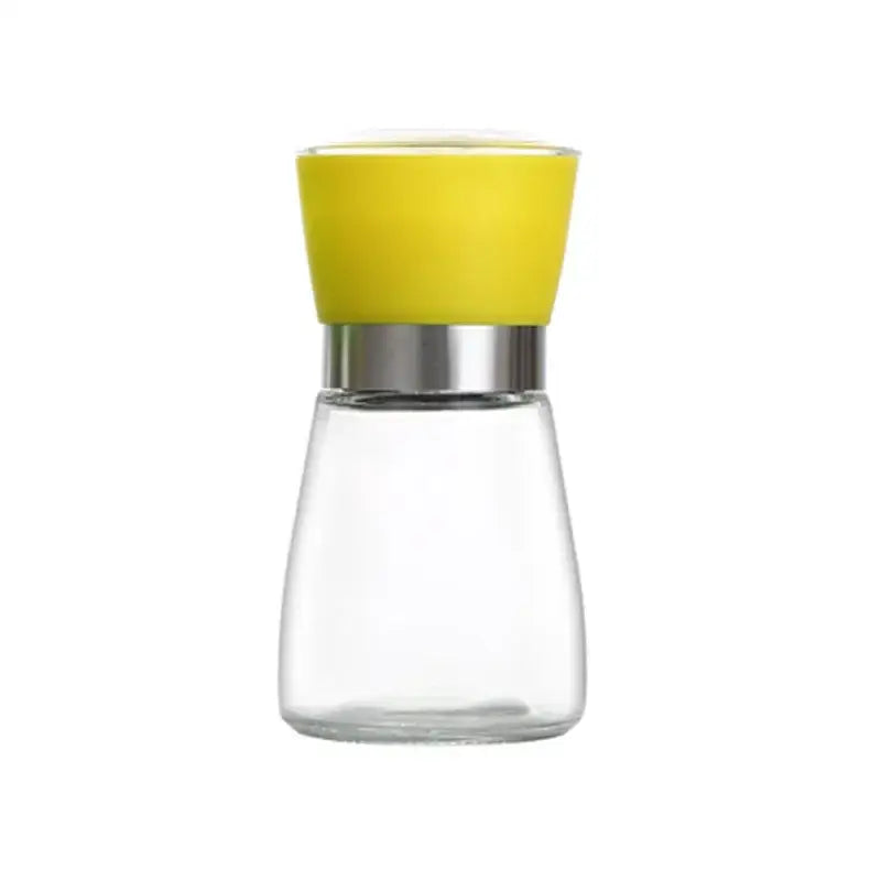 Adjustable spice grinder clear glass pepper mill with vibrant yellow silicone top and metallic silver band for kitchen use