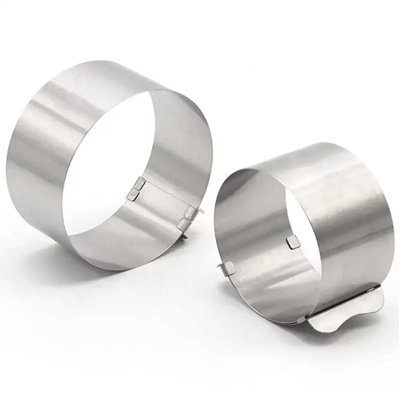 Two sleek silver stainless steel cake rings with hinged clasps from decorbites adjustable stainless steel slicer set
