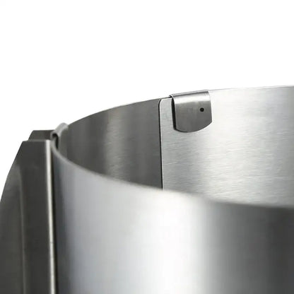 A sleek brushed stainless steel adjustable mousse ring round cake slicer with polished finish and secure clasp mechanism