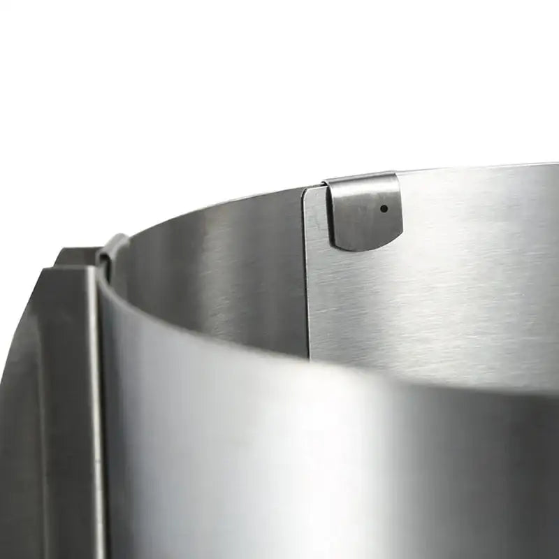 A sleek brushed stainless steel adjustable mousse ring round cake slicer with polished finish and secure clasp mechanism