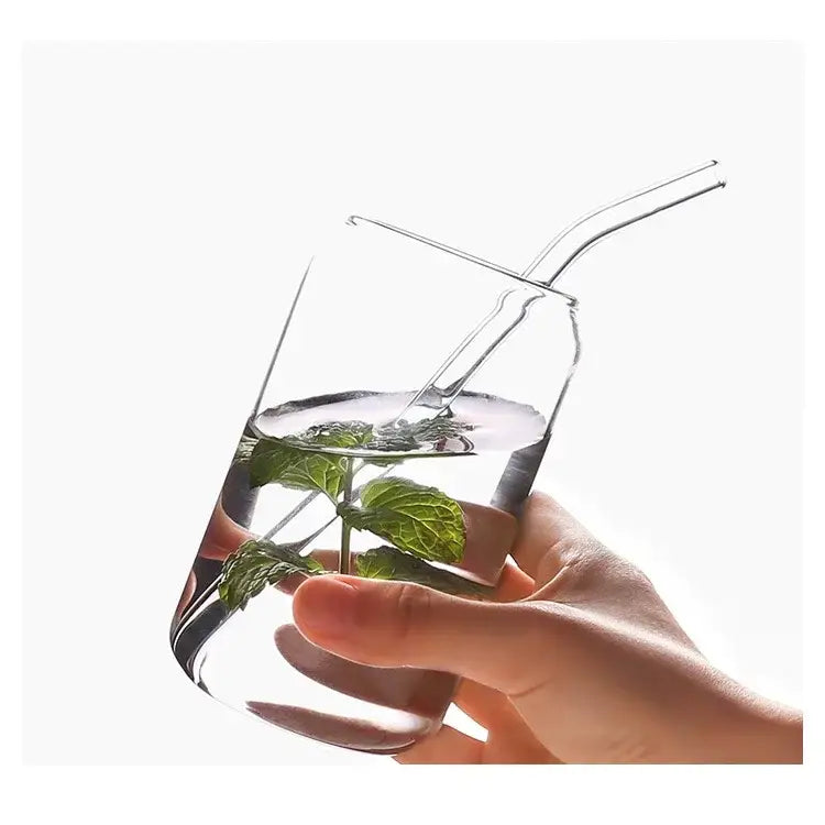 Clear glass aesthetic drinking glass with curved straw filled with water and fresh mint leaves from drinking glasses set