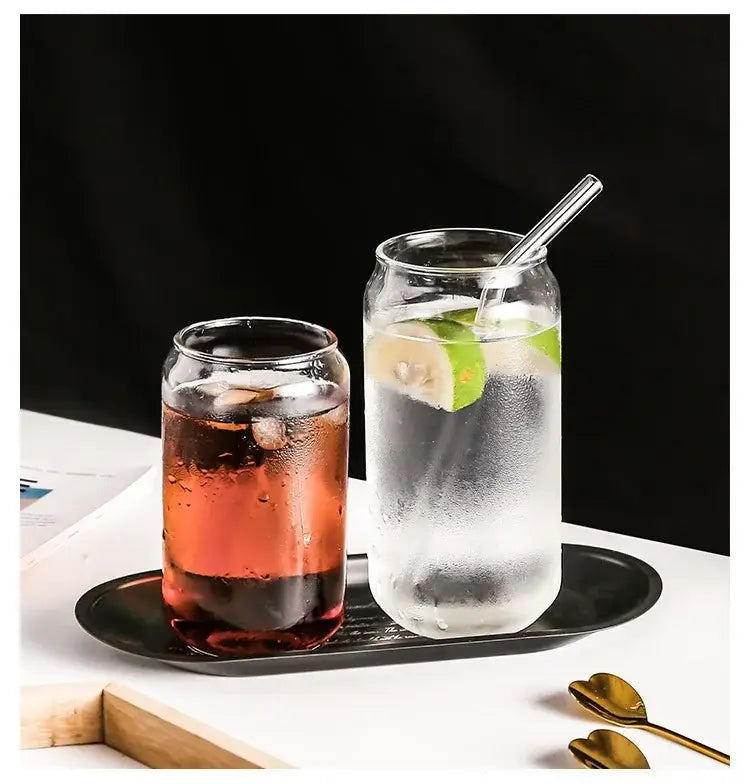 Two clear aesthetic drinking glasses set with lids and straws one filled with dark red beverage the other sparkling with lime slices