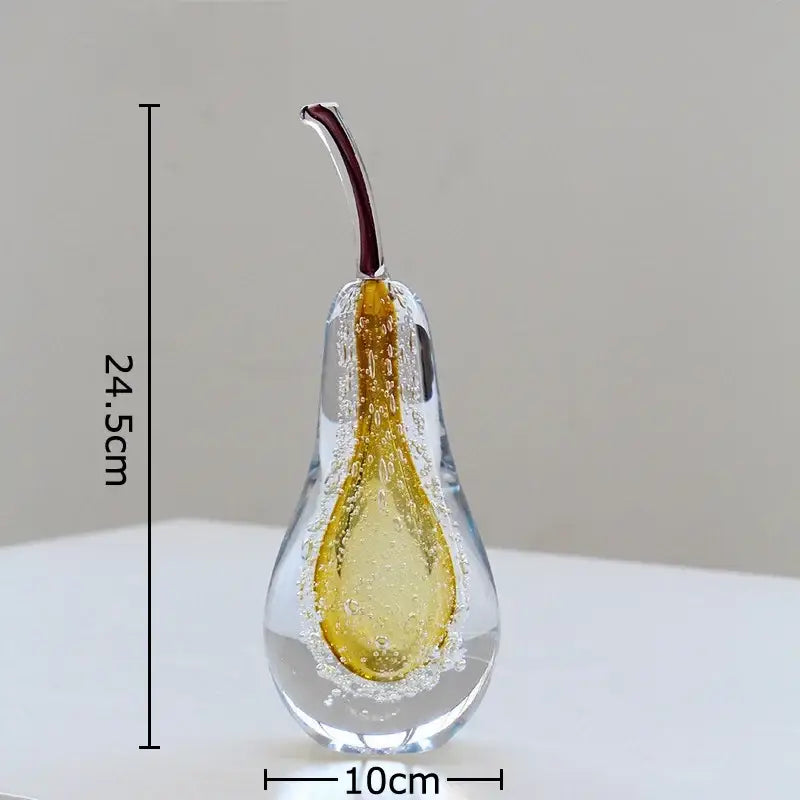 A translucent green and gold glass fruit sculpture desk ornament shaped like a pear with a maroon stem measuring 24.5cm tall