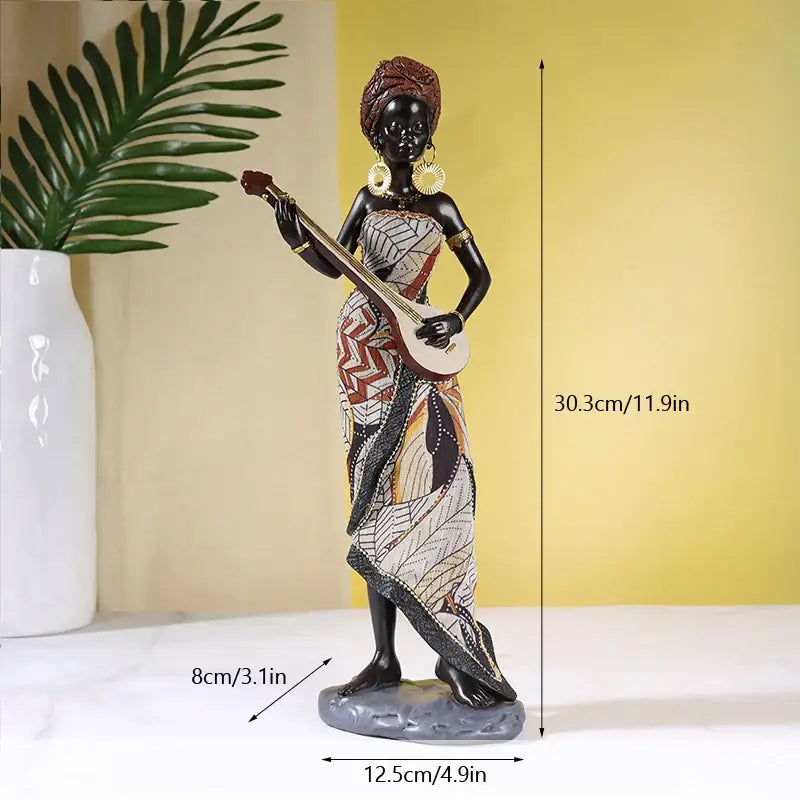 A detailed resin african exotic black mother figurine holding a string instrument with patterned dress decorbites african exotic