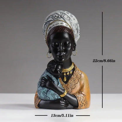 A glossy black resin african mother child abstract bust sculpture with white headwrap and gold jewelry for decorbites decor
