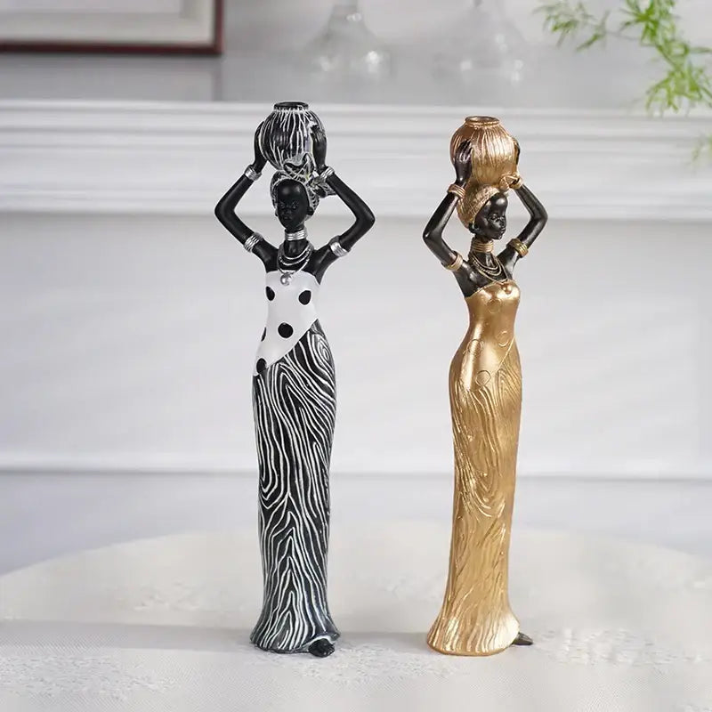 Two elegant decorbites black woman resin figurines in zebra patterns and gold gown for living room decor accents