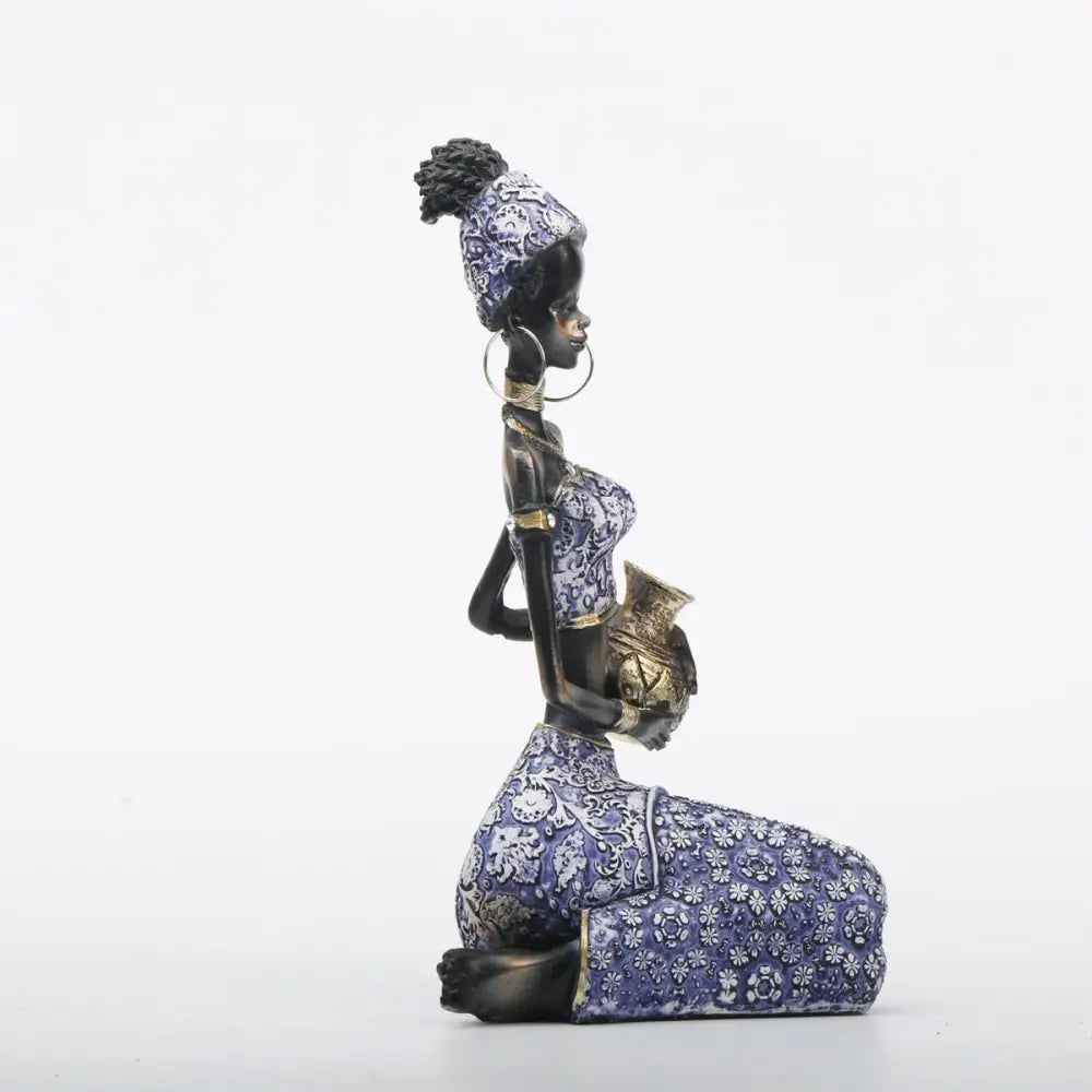 African woman sculpture kneeling figurine in purple and gold patterned dress for DecorBites living room decor
