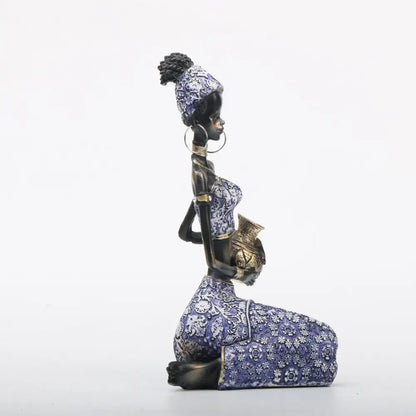 African woman sculpture kneeling figurine in purple and gold patterned dress for DecorBites living room decor