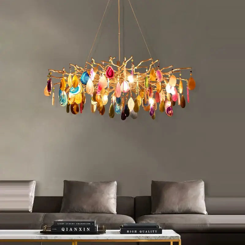 A vibrant gold-toned decorbites agate designer led chandelier with colorful translucent agate slices for dining room decor