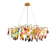 A decorbites agate designer led chandelier with gold branches and colorful teardrop agate slices for dining room decor
