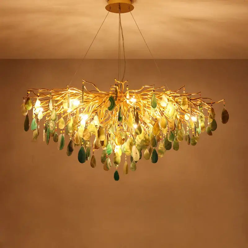 A golden agate designer led chandelier with intricate branch arms and green yellow agate slices for dining room decor
