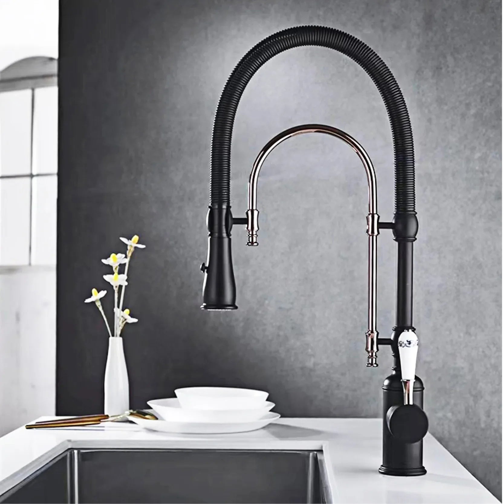 Black and chrome kitchen faucet with flexible gooseneck spout and pull-down spray head for single hole single handle use