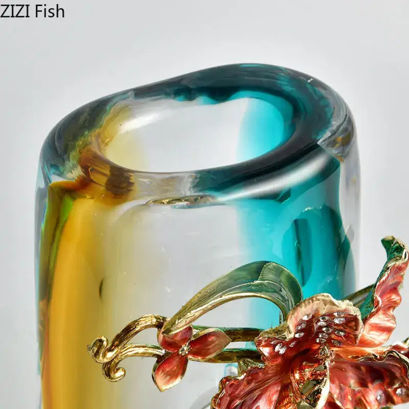 A hand-blown blue gradient glass vase with amber hues and red gold floral decorbites blue gradient embellishments