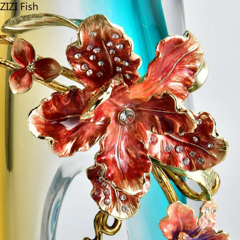 A vibrant red and gold enamel flower brooch with rhinestones displayed alongside a blue gradient glass floral relief vase decorbites for living room decor