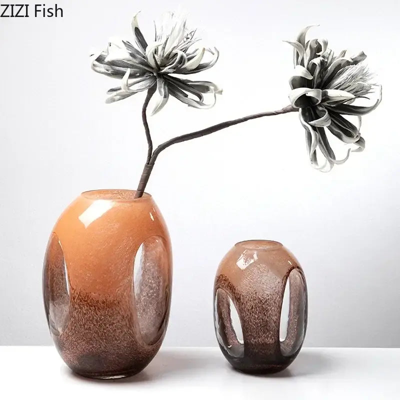 Two decorbites dual color glass vases with oval shapes and cut-out panels in amber and brown for living room decor