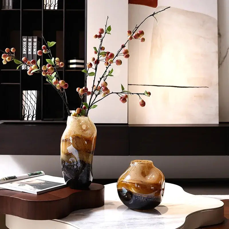 A tall ceramic decorbites gradient glass vase with amber and brown hues featuring an irregular floral arrangement