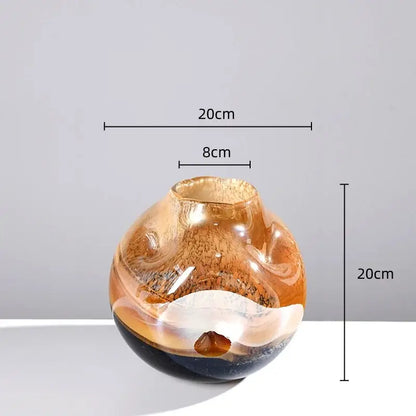A translucent amber gradient glass vase with swirling dark brown and white marbled patterns for irregular floral arrangement