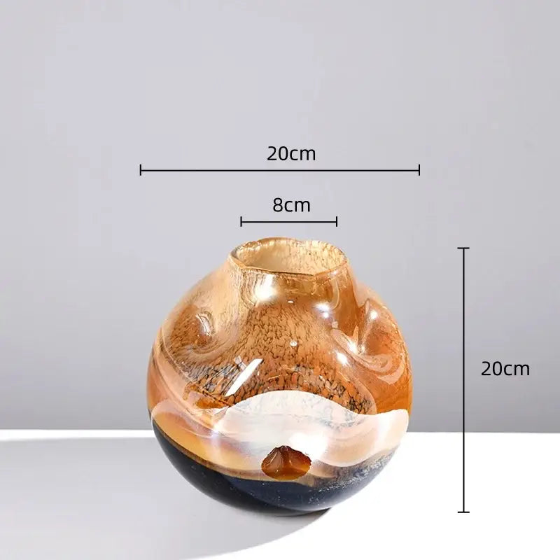 A translucent amber gradient glass vase with swirling dark brown and white marbled patterns for irregular floral arrangement