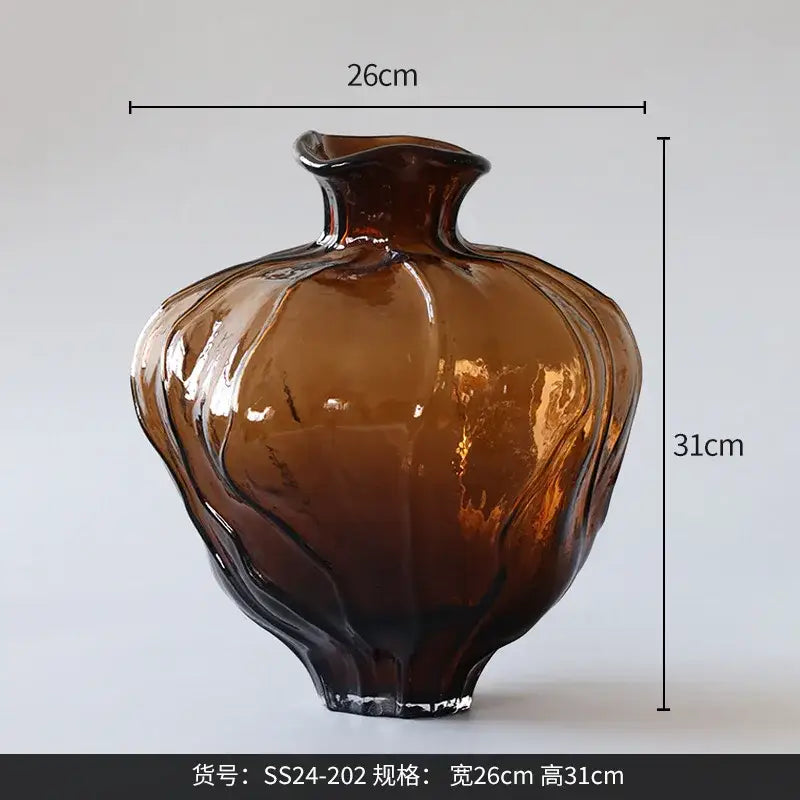 A glossy amber brown wavy grain glass pumpkin vase with a fluted shape and irregular rim for living room decor