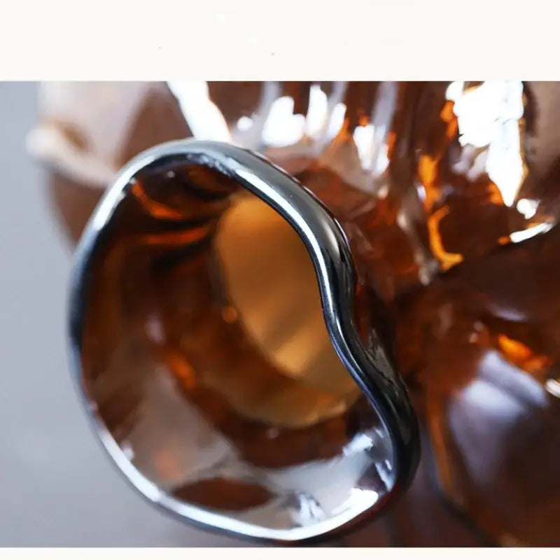 A sleek silver-toned metal ring with a smooth reflective surface complements decorbites brown wavy grain glass pumpkin vase decor