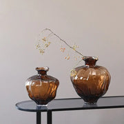 Two amber brown wavy grain glass pumpkin vases with faceted design on dark table for living room decorbites decor