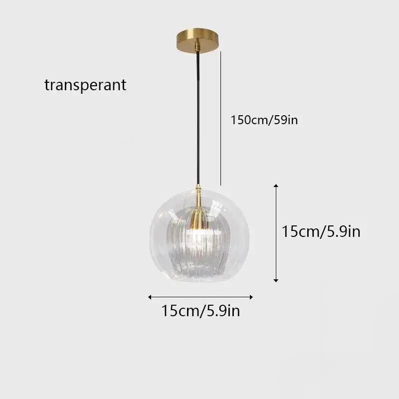 Amber and clear glass pendant light with a transparent ribbed globe and gold metal hardware for kitchen use