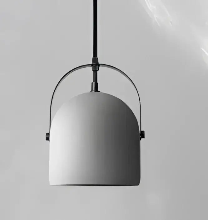Minimalist gray concrete pendant light with sleek dome shade and curved metal frame for dining room use