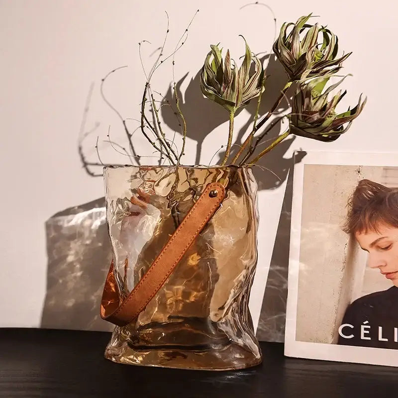 Amber translucent hammered gold bag shape glass vase with tan leather strap for living room decor